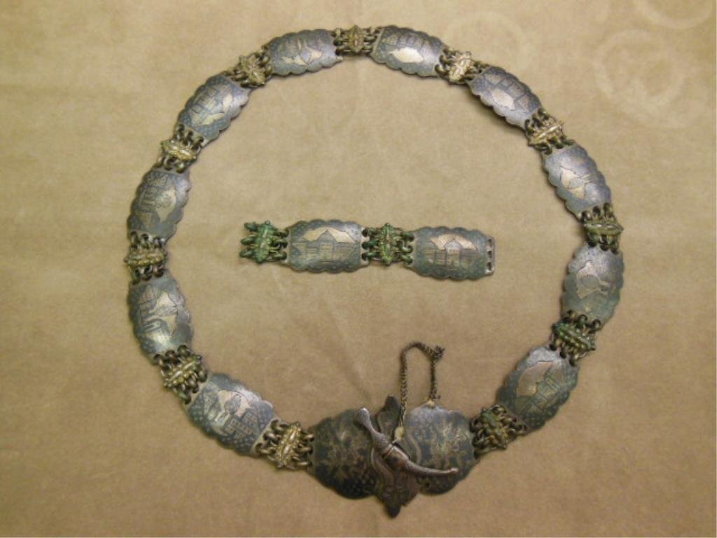 Persian Niello Silver Belt: Persian Niello silver belt, The Niello low grade silver (tested) panels depict cityscapes, the buckle with etched floral motifs and a sword lock. The cartouche and lings joining the Niello panels are 