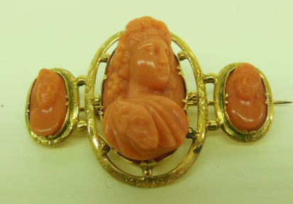 Carved Coral Triple Cameo Pin: Carved coral triple cameo pin, mid 19th c., tested 14k chaised frame supports high relief 3/4 frontal view of Bacchante in center with two side carved coral cameos, 24 x 14mm center cameo, 12 x 6mm si