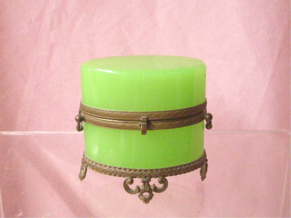 19th c. Opaline Glass Jewelry Casket: Late 19th c. French green Opaline glass 3 1/2" x 3 14" x 2 1/4" oval jewelry casket with applied brass mounts and handles. CONDITION: Very good with minor wear and no damage.