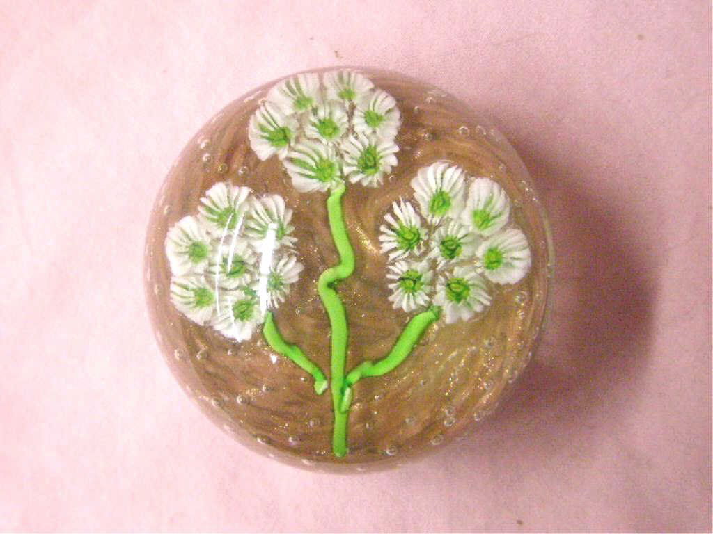 Vintage Italian Glass Paperweight: Unsigned vintage Italian glass 1 1/2" x 2 1/2" paperweight, green and white caned flower on a coppered mica flake and bubble background. CONDITION: Very good with minor wear and no damage.