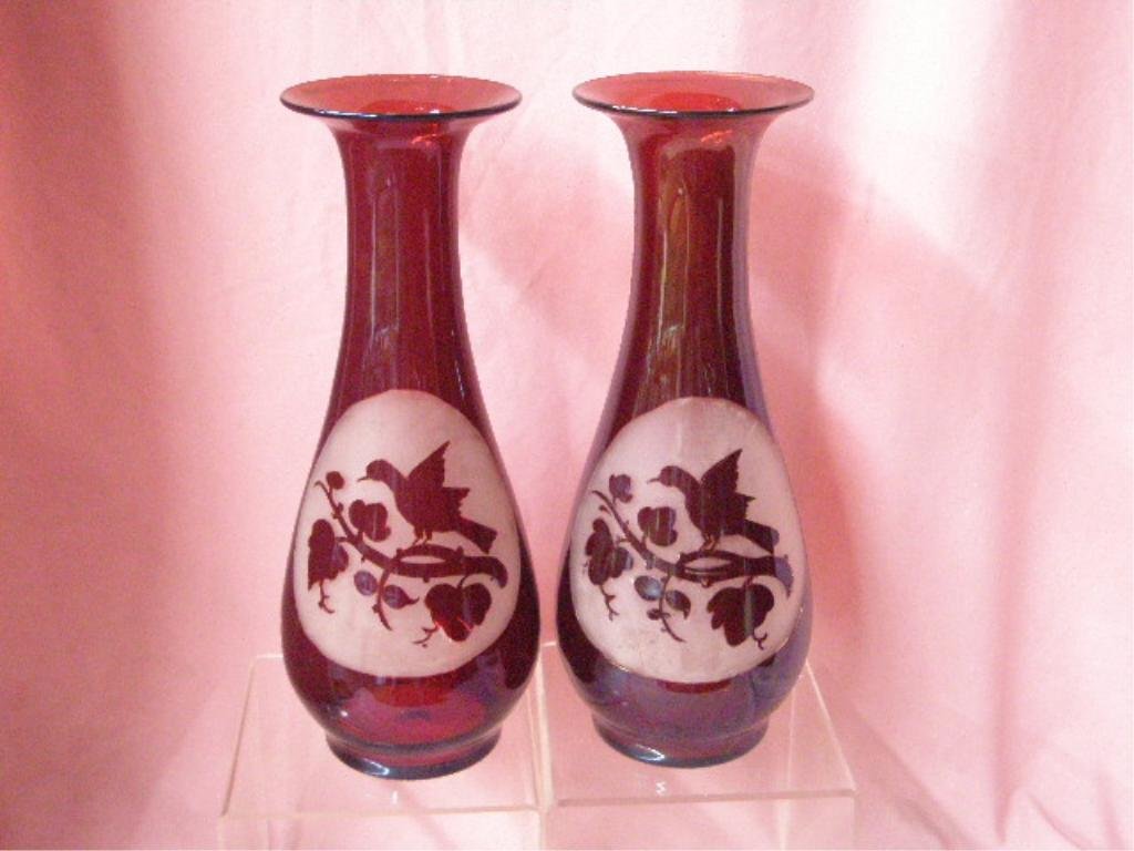 Victorian Ruby Glass Bird Vases: Pair of Victorian ruby flashed glass 12 3/4" vases with bird and leaf decorated frosted trim center cartouches. CONDITION: Both have wear, scratches and rough pontil marks on base, areas with wear and