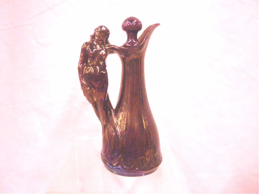 Zsolnay Pottery Red Eosin Cruet: Late 19th/early 20th c. Zsolnay pottery red Eosin glazed 7" Art Nouveau female handle cruet bottle with stopper. CONDITION: Small chip on female's nose, wear and loss on base.