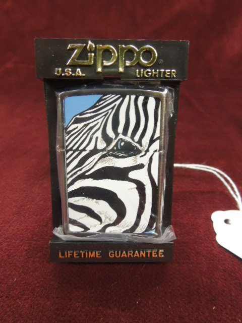 Zippo Lighter "Zebra": Zippo lighter ' "Zebra", front & backside, 1996, Barrett - Smythe collection, new, old stock in plastic bag with plastic flip front Zippo case. CONDITION: New old stock.
