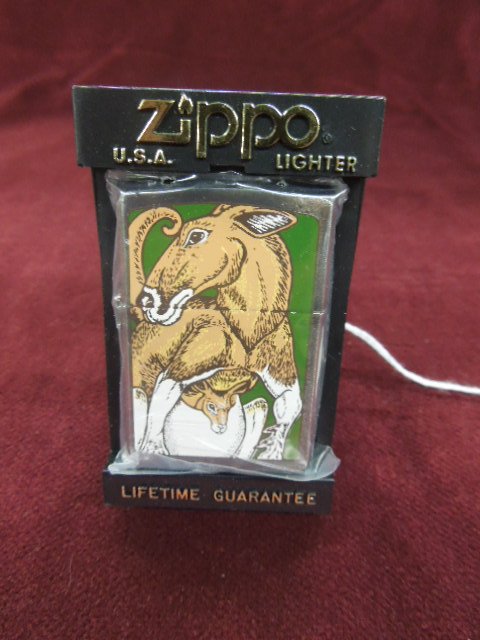 Zippo Lighter "Kangaroo w/ Joey": Zippo lighter - "Kangaroo with Joey" (baby kangaroo), front & backside, 1994, Barrett - Smythe Collection, new old stock in plastic bag with plastic flip front Zippo case. CONDITION: New old stock.