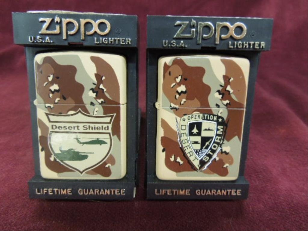 2 Zippo Lighters-"Desert Storm" & "Desert Shield": 2 Zippo lighters - "Desert Storm" and "Desert Shield", both with insignia, camouflage front, and backside, model # on storm - 213 DST, both new old stock in plastic flip front Zippo cases.