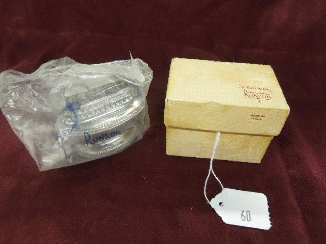 Ronson Queen Anne Lighter: Vintage Ronson silverplate Queen Anne table top / desk top lighter with original box, sealed in package. CONDITION: Lighter is very good with no damage, box has wear and staining.