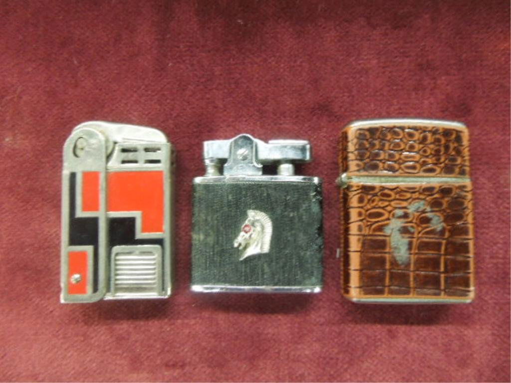 3 - Vintage Cigarette Lighters: Three vintage cigarette lighters, Champ faux alligator (made in Austria), Regens Art Deco designed and Kent with applied horse head. CONDITION: All have some form of wear.