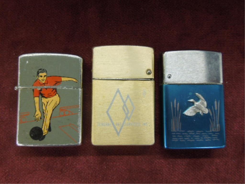 3 - Vintage Cigarette Lighters: Three vintage cigarette lighters, Kron bowling theme (made in Japan), Wind Master "General Art Services, Inc." and Wind Master duck theme. CONDITION: All have some form of wear.