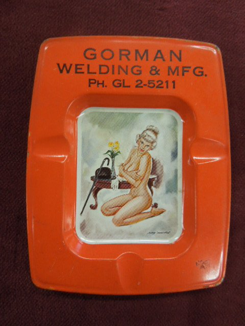 Tin Pin-up Ad Ashtray: Tin pin-up advertising ashtray from Gorman Welding & Mfg. with old telephone # GL2-5211, reddish orange border with picture in center, unpainted back. CONDITION: Minor wear and paint loss,