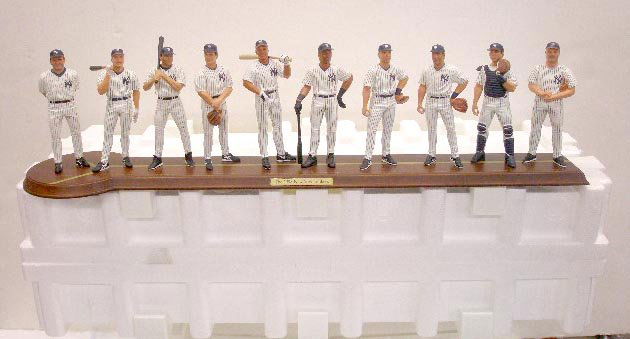 Danbury Mint New York Yankees Team Figurine: 1999 Danbury Mint 1998 New York Yankees World Series Champions team 28" x 7" figurine, depicts 10 individual statues of the starting line up & Joe Torre. CONDITION: Very good with no damage.