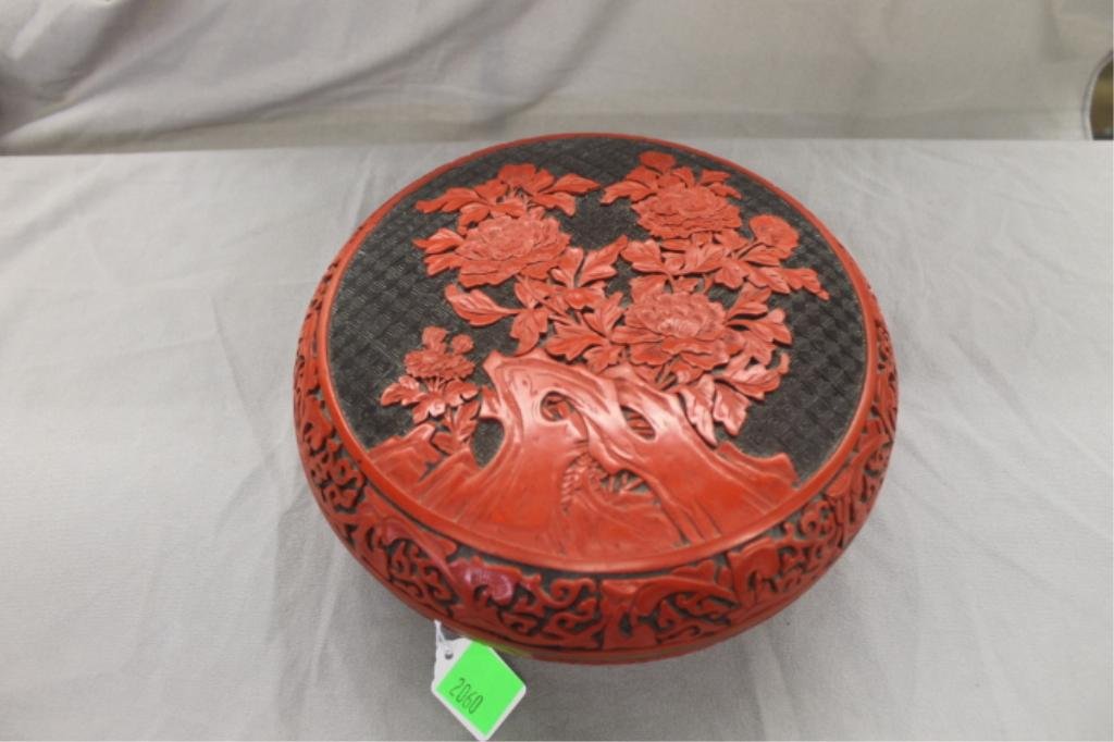 Chinese Round Cinnabar Box: Chinese round Cinnabar box, scroll work and floral design, brass rims, 10"d x 4 1/4"h, 20th c. CONDITION: No issues noted.