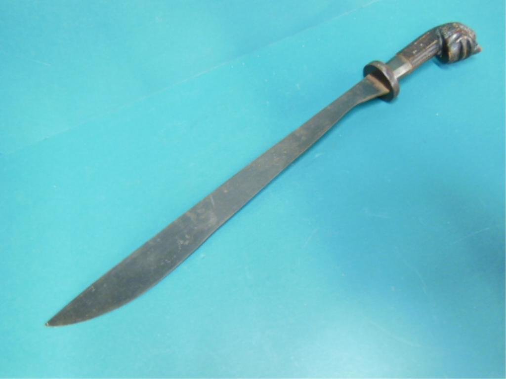 Machete w/Wood Carved Dragon Head: Machete with wood carved dragon head handle, 27 1/2"l no marking, 19th/20th c. CONDITION: Some pitting on flat side of blade.