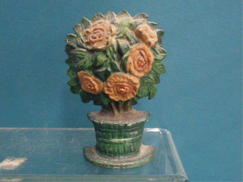 Cast Iron Flowers in Vase Doorstop: Antique painted cast iron 6 3/4" x 4 1/2" Flowers in Vase doorstop. CONDITION: Areas with wear, loss & overpaint.