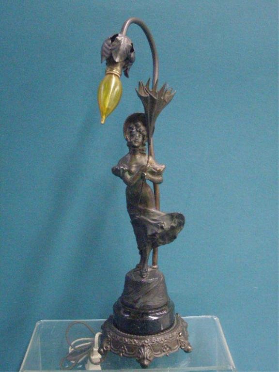 German Figural Metal Table Lamp: Antique German cast metal 18" table lamp, 12 1/2" Art Nouveau style female figure mounted onto a black marble base & set into lamp mount. CONDITION: Very good with minor wear, needs to be re-wired.
