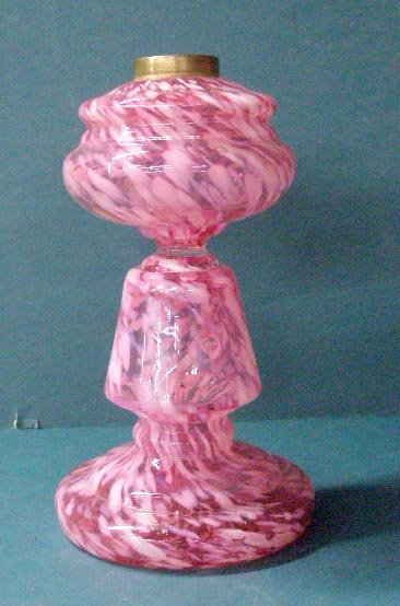 Cranberry Opalescent Glass Oil Lamp: Victorian Cranberry Opalescent glass 8" oil lamp with original brass fitting. CONDITION: 2 1/2" crack on top near fitting, rough pontil mark on base.