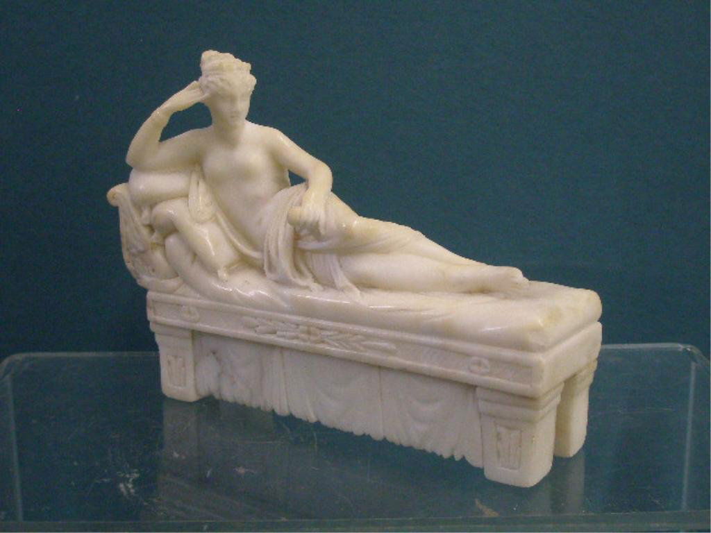 Antique Marble Nude Female Figure: Late 19th/early 20th c. Continental carved marble 5" x 6 1/2" 2" figure of a nude Roman female reclining on a chaise. CONDITION: Reglued back legs on chaise, big toe missing on right foot, areas with