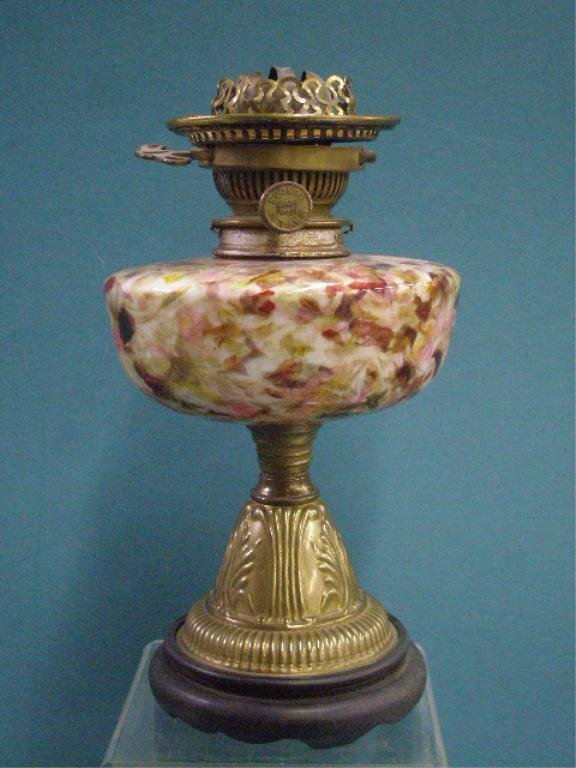 Victorian Spatter Glass Oil Lamp: Victorian Spatter glass & brass base 10 1/4" oil lamp with original Hicks & Son (London) patent brass fittings, mounted onto a 1 1/2" black wood base. CONDITION: Very good with wear on brass.