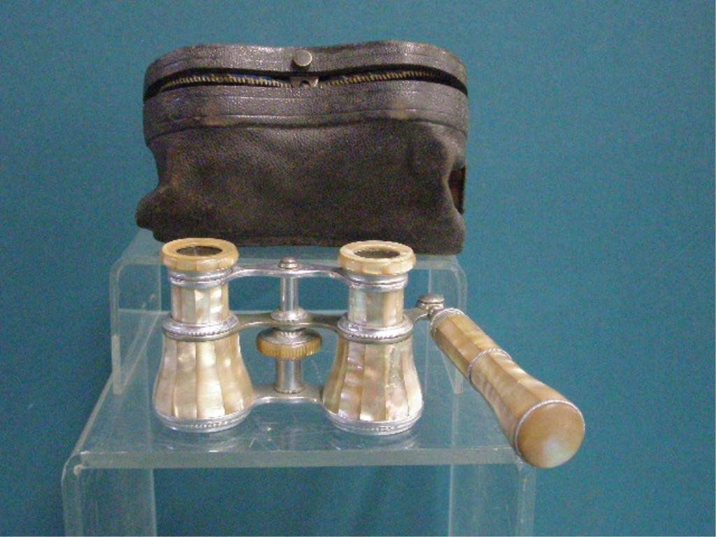 Antique Opera Glasses: Pair of early 20th c. Mother of Pearl & silvered metal 2 1/2" x 3 1/2" handled opera glasses with original leather case. CONDITION: Very good with minor wear, case has wear & tearing.