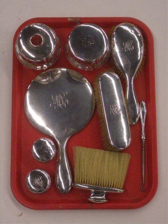 Antique Sterling Silver Dresser Set: Early 20th c. nine piece sterling silver dresser set, includes: 10 1/2" hand mirror, 8 1/2" hand brush, 6 1/2" shoe brush, 4" clothes brush, 7 1/2' button hook, 3" cut glass powder jar & hair receiver