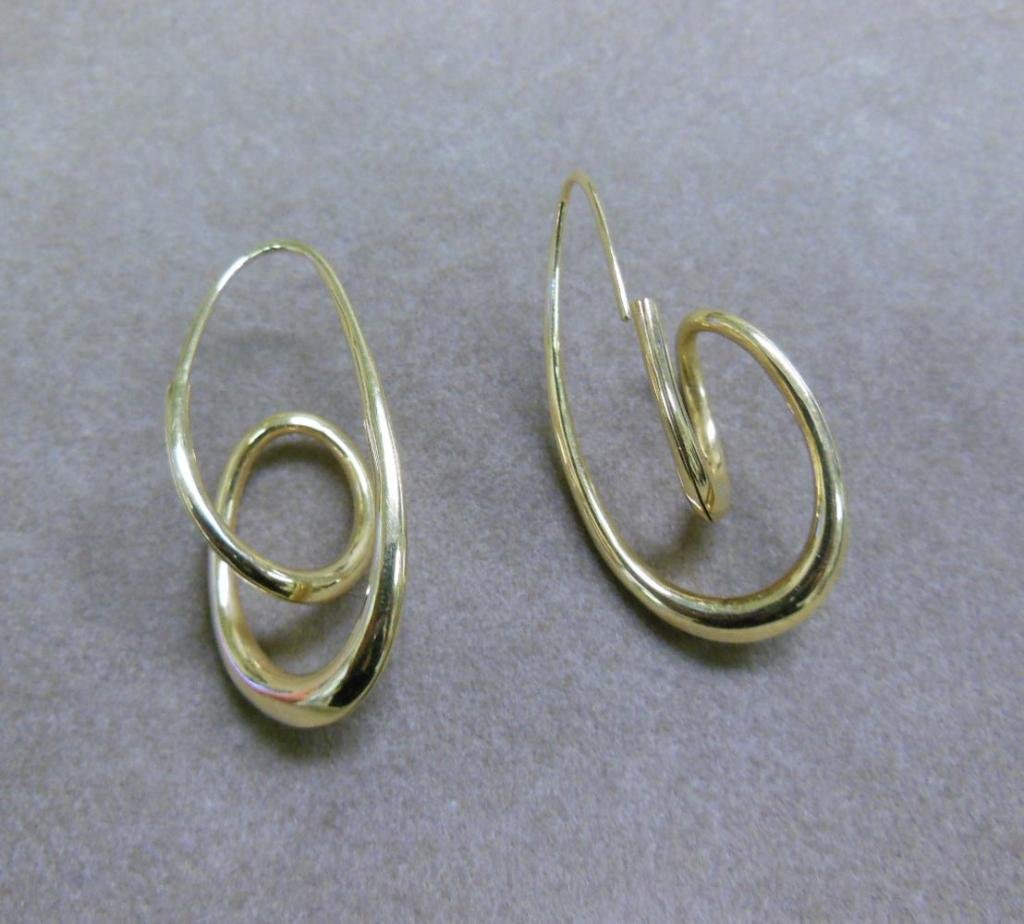 18k YG Michael Good Earrings: 18k yellow gold Michael Good earrings, "Helicoidal" anticlastic twisted spiral loops, marked copyright M.Good, 750, 1 1/2" length, 4.5 DWT. CONDITION: Excellent.