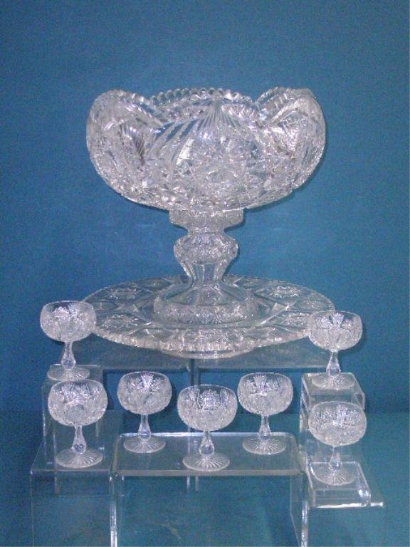 Brilliant Cut Glass Punch Set: Antique American brilliant cut glass 8 piece punch bowl set, 14" x 13" two piece punch bowl (7 1/2" x 12 1/2" bowl & 7 1/2" x 6" base) that sits into a 2 1/2" x 15 1/2" round base tray & seven 3 3/4" 