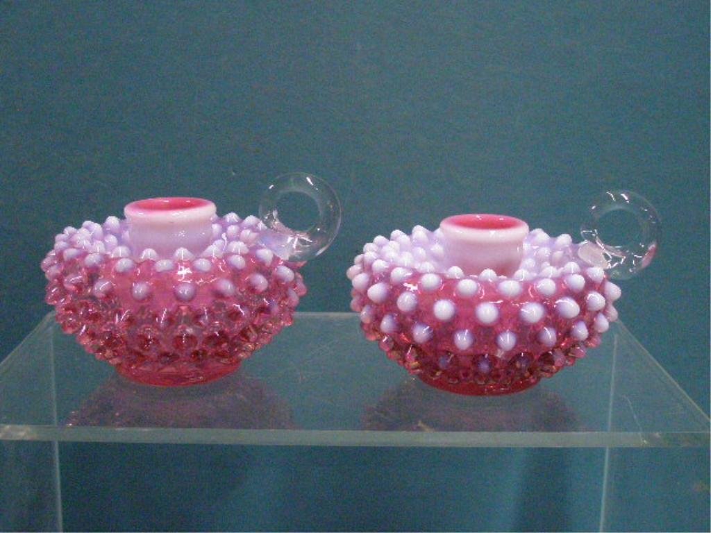 Fenton Glass Hobnail Candlesticks: Pair of vintage Fenton glass cranberry opalescent hobnail 3" x 4 1/2" handled candlesticks. CONDITION: Both are very good with no damage.