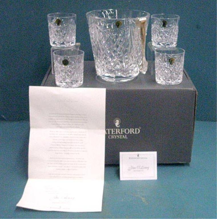 Waterford Jim O'Leary Ice Bucket Set: Waterford crystal Jim O'Leary designer signed five piece Jim O'Leary Century Ice Bucket with DOF's & tongs, 7 1/2" ice bucket & four 3 1/2" old fashioned glasses, with paperwork & box. CONDITION: Very
