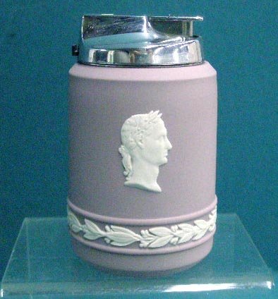 Wedgwood Jasperware Lighter: Wedgwood lilac Jasperware 3 1/2" table top lighter with figural head & floral band designs. CONDITION: Non working with no damage.