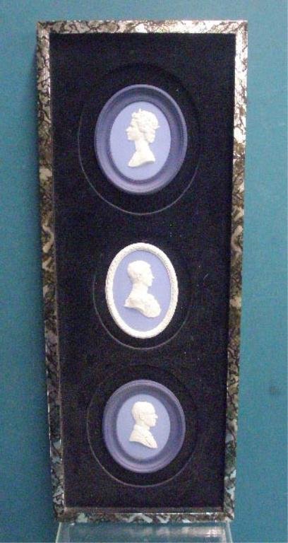 Wedgwood Jasperware Commemorative Plaques: Three Wedgwood blue Jasperware British royalty commemorative plaques, set & mounted into a 8" x 22 1/2" frame, 4 1/2" x 3 3/4" Queen Elizabeth II Silver Jubilee, limited edition #1405/2,000, 4 1/2" x