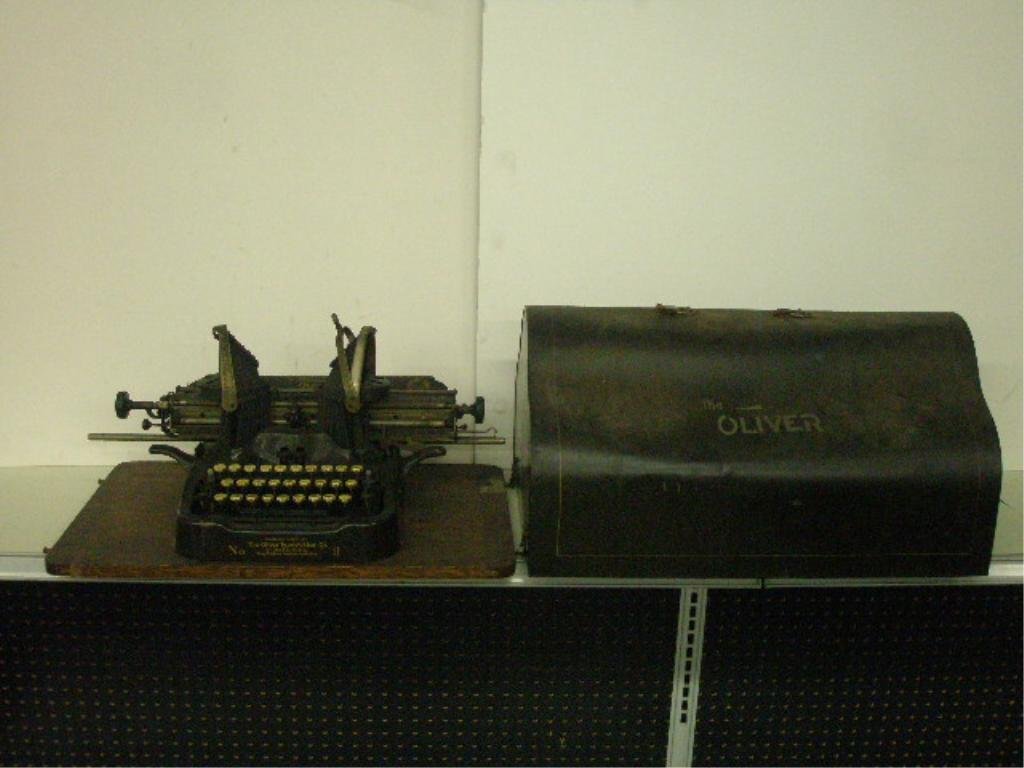 1912 Oliver No. 9 Standard Visible Typewriter: Circa 1912 The Oliver Typewriter Co. No. 9 Printype standard visible typewriter on wood base, with original metal lid. CONDITION: Areas with wear, dents on metal lid.