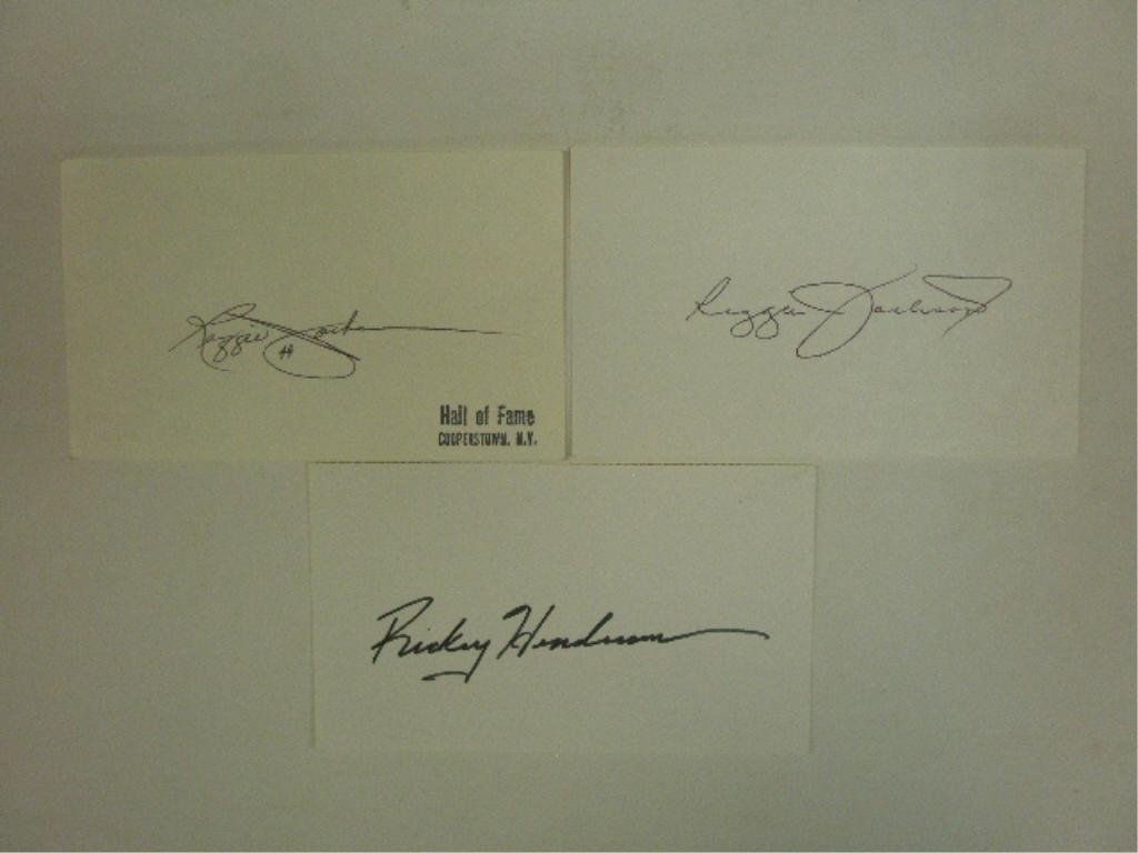 Rickey Henderson & Reggie Signed Index Cards: Rickey Henderson & two Reggie Jackson signed 3" x 5" index cards, no C.O.A. for authenticity or guarantee of signatures being real. CONDITION: All are very good with minor wear, 1 Jackson has postal c
