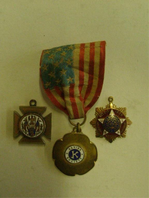 Early 20th c. Organization Pendant: Early 20th c. organization enameled pendants includes: K Saving Society, with ribbon (no pin), U.S. Brewers Association and F.O.E.A. CONDITION: Some wear from age.