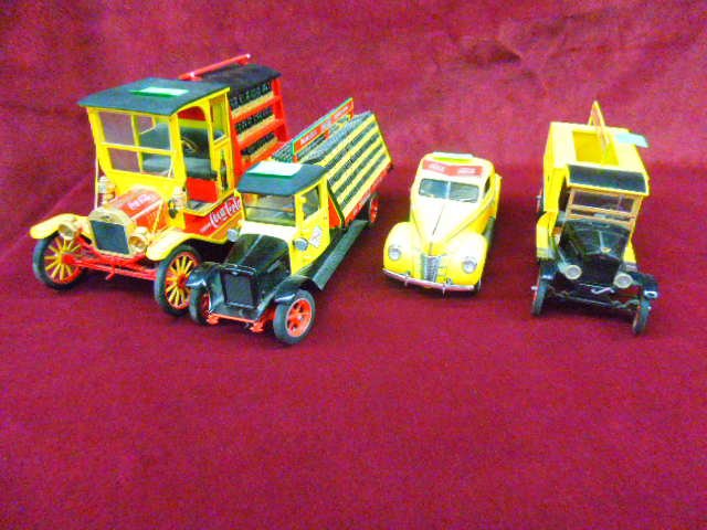 4 Coca Cola Die Cast Vehicles: Lot of 4 Coca-Cola Themed die cast vehicles. (1) Franklin Mint Model T Ford truck, Ford truck, International truck & Coupe from The Danbury Mint. CONDITION: Some wear from age sign broke of one vehicl