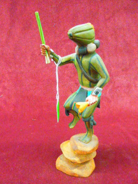 Kachina Doll "Squash Head": Contemporary Southwest Hopi Kachina doll; "Squash Head", Patung (runner), artist signed, Watson Namoki, hand carved polychrome hand painted figure, staff & flower, 9 1/4" h. on rock form base CONDITIO