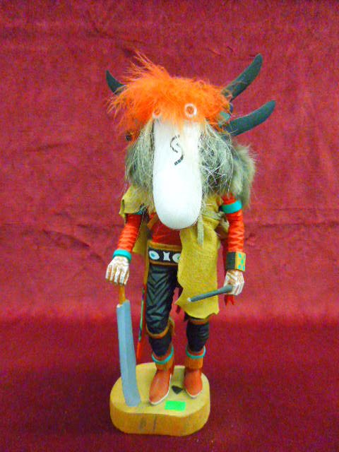 Hopi Kachina Doll; "Nataska": Contemporary S.W. Hopi Kachina doll; "Nataska" with saw & bow, artist signed "Calvin Yoyetewa", hand carved, polychrome hand painted with fur, feathers & leather vest, 14 3/4" h. CONDITION: One wood h