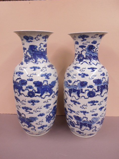 Pair Chinese Blue & White Porcelain Vases: Pair Chinese Blue & White porcelain vases, depicting clouds & foo dogs, 19th/20th C. hgt 24 1/4". [10] CONDITION: Very good.