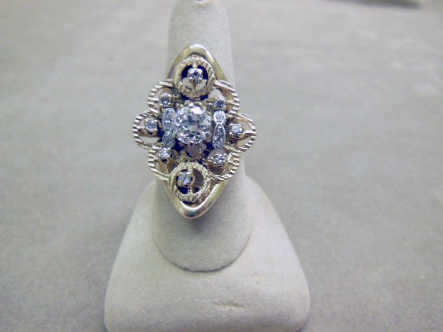 14k YG 1ct Diamond Ring: 14k YG 1ct diamond ring, vintage custom designed with approx 1ct solitaire round center diamond, surrounded by 12 accent round & 2 marquise diamonds, embossed circles atop polished navette shape mount