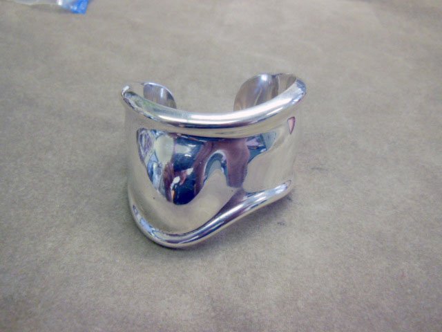 Tiffany & Co. Peretti Cuff Bracelet: Tiffany & Co. Peretti cuff bracelet, sterling "Bone Cuff" bracelet signed Peretti (Elsa Peretti) Italy. 2" inside across, 1.95ozt. Tiffany pouch. CONDITION: Pre-owned, very fine, minor surface scratch