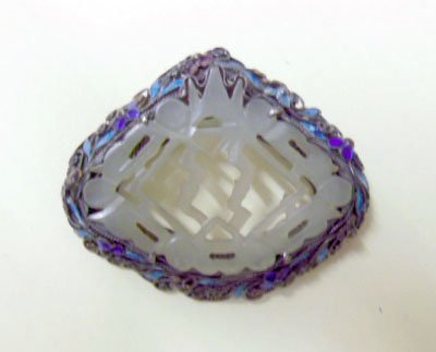 Chinese Silver, Jade & Enameled Pin: Chinese silver, jade and enameled pin, pierced carved celadon green jade center set in an enameled floral filigree frame marked "Silver", early 20th C., 2" x 2 1/4". CONDITION: No issues identified.