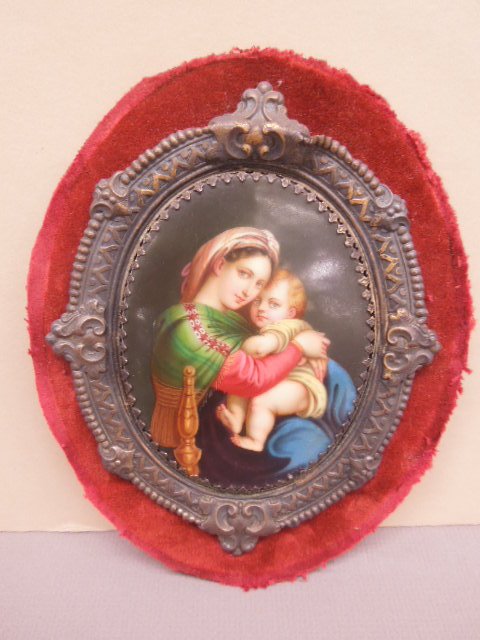Painted Porcelain Oval Panel: Painted porcelain oval panel, depicts mother holding a child, Victorian brass frame on red velvet panel, sight 3 7/8" x 5", brass frame 6" x 7 1/2". CONDITION: No issues noted.