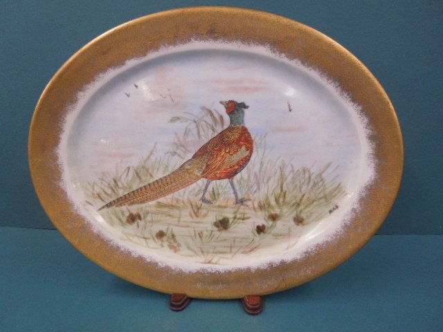 Limoges Porcelain Platter: Limoges porcelain platter, hand painted and transfer printed pheasant in field, gilt border, early 20th C., 16" x 12 1/2". CONDITION: No issues identified.