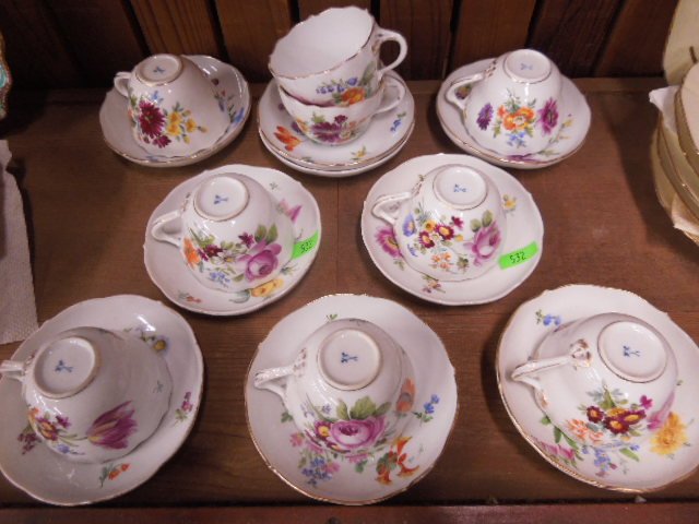 Set of 9 Meissen Porcelain Cups & Saucers: Set of 9 Meissen porcelain cups & saucers, hand painted floral motifs, cross sword mark on base, 19th/20th c. CONDITION: Minor gold highlight losses.