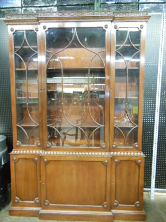 Williamsburg Restoration Chipp. Style Breakfront: Williamsburg Restoration of Kittinger Style Chippendale style breakfront, mahogany, 2 parts, with lattice, rosette oriental gable carvings, mid 20th C. CONDITION: Repair to rear bottom corner of upper