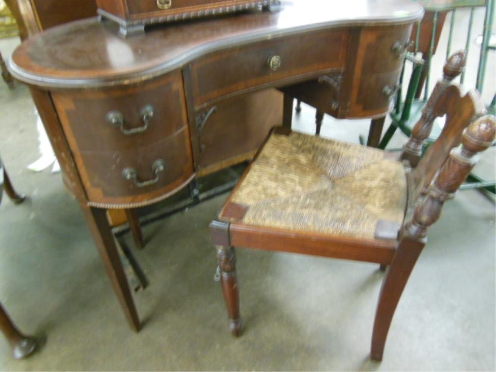 Hepplewhite Style Vanity & Chair: Hepplewhite style vanity and chair, banded mahogany, kidney shaped, along with Sheraton style rush seat chair, mid 20th C. CONDITION: Loose vanity top, scratches; losses to rush seat.