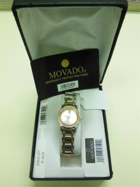 Movado Replica Lady's Wrist Watch, SS: Movado replica lady's wrist watch, stainless steel & gold plated, quartz, silvered dial, CZ, bezel, 1043289. [34] CONDITION: New in box.