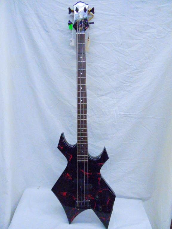 B.C. Rich NJ Series Elec. Bass Guitar SER# B3270: B.C. Rich NJ Series Elec. Bass Guitar SER# B3270 with case. Condition: Fair used. Has paint splatter throughout, missing intonation cover, chips, scratches etc.