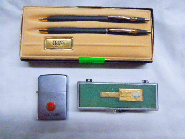 RCA Collectible Lot: RCA Collectible Lot. Includes: RCA Zippo lighter, RCA Tie Clip, RCA Cross Pen Set. Condition: Fair used.