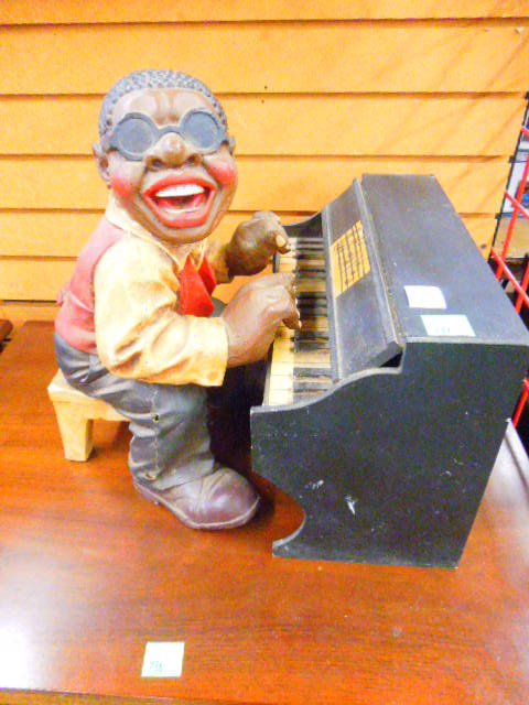 Composition Piano Player Figure: Composition Piano Player Figure. Condition, some breakage measures 17" x 16" x 13.5"