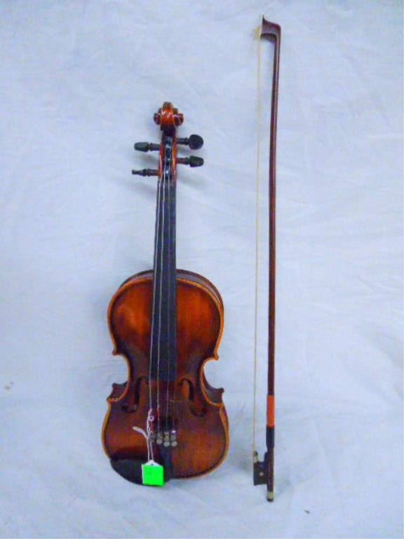 Violin Stradivarius Copy: Violin, 1/4, Stradivarius copy, made in Germany, with bow & lined hardcase, missing bridge. CONDITION: No issues identified.