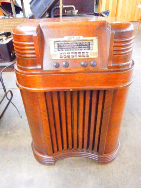 Philco Floor Model Radio: Philco floor model radio, with television broadcast sound, walnut waterfall case. CONDITION: Scratches & dings, deteriorating to bakelite push buttons, not working.
